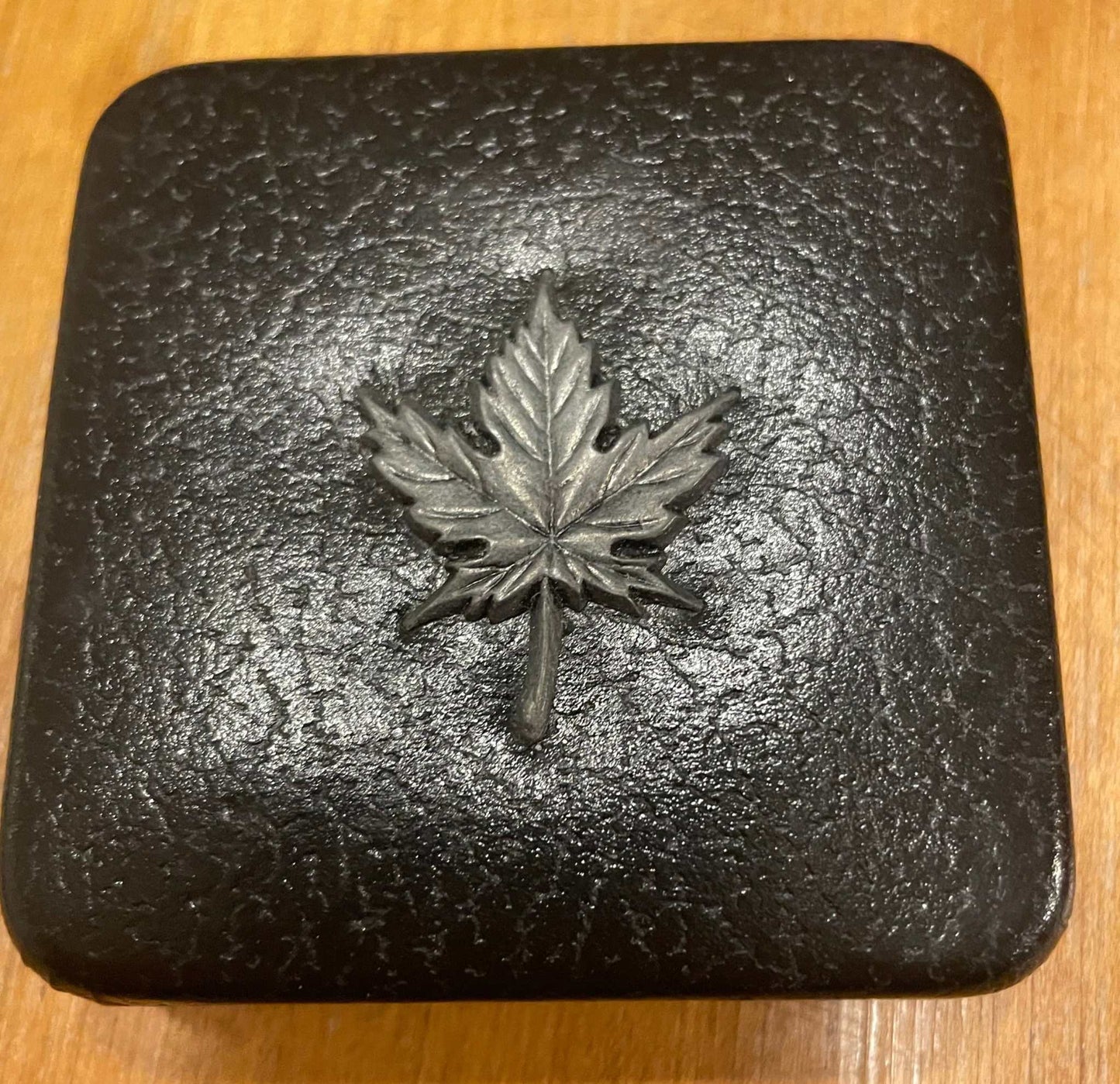 1983 commemorative medal case with Canadian maple leaf emblem.