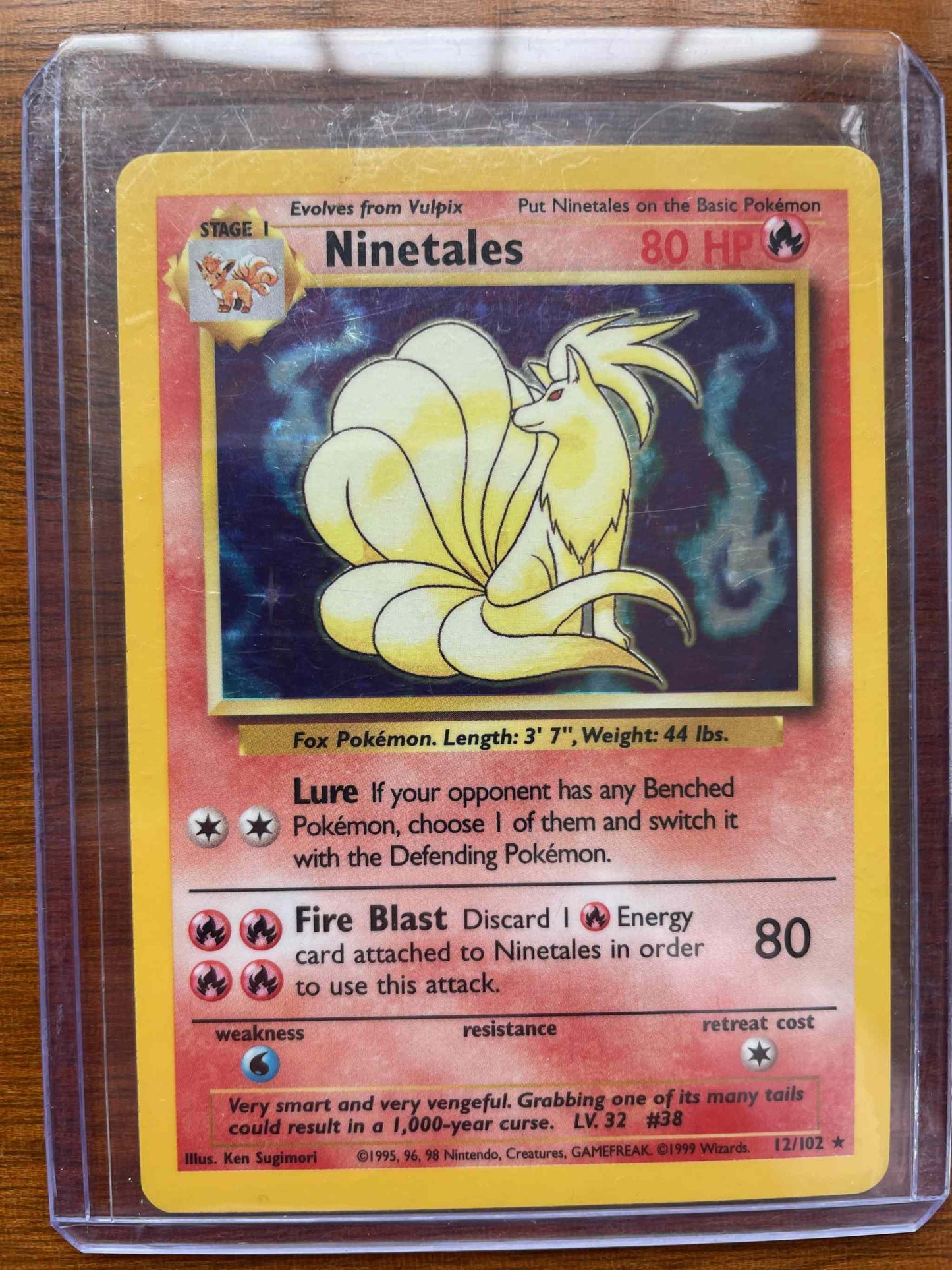Base Set 2 #012/102 Ninetales holographic Pokémon card in protective sleeve.