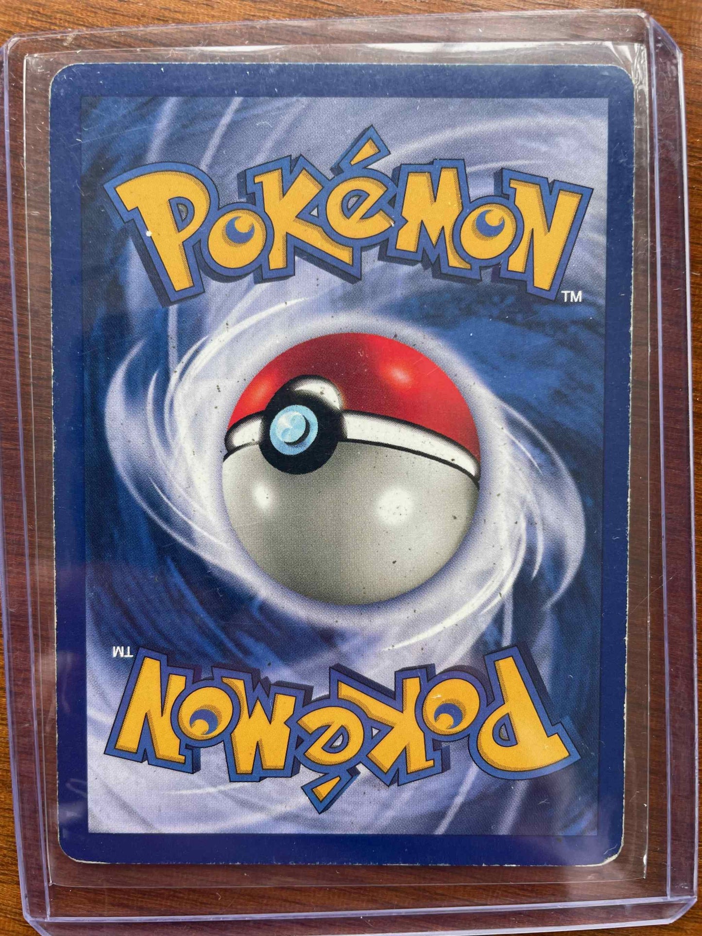 Base Set #013/102 Poliwrath collectible card in protective sleeve.