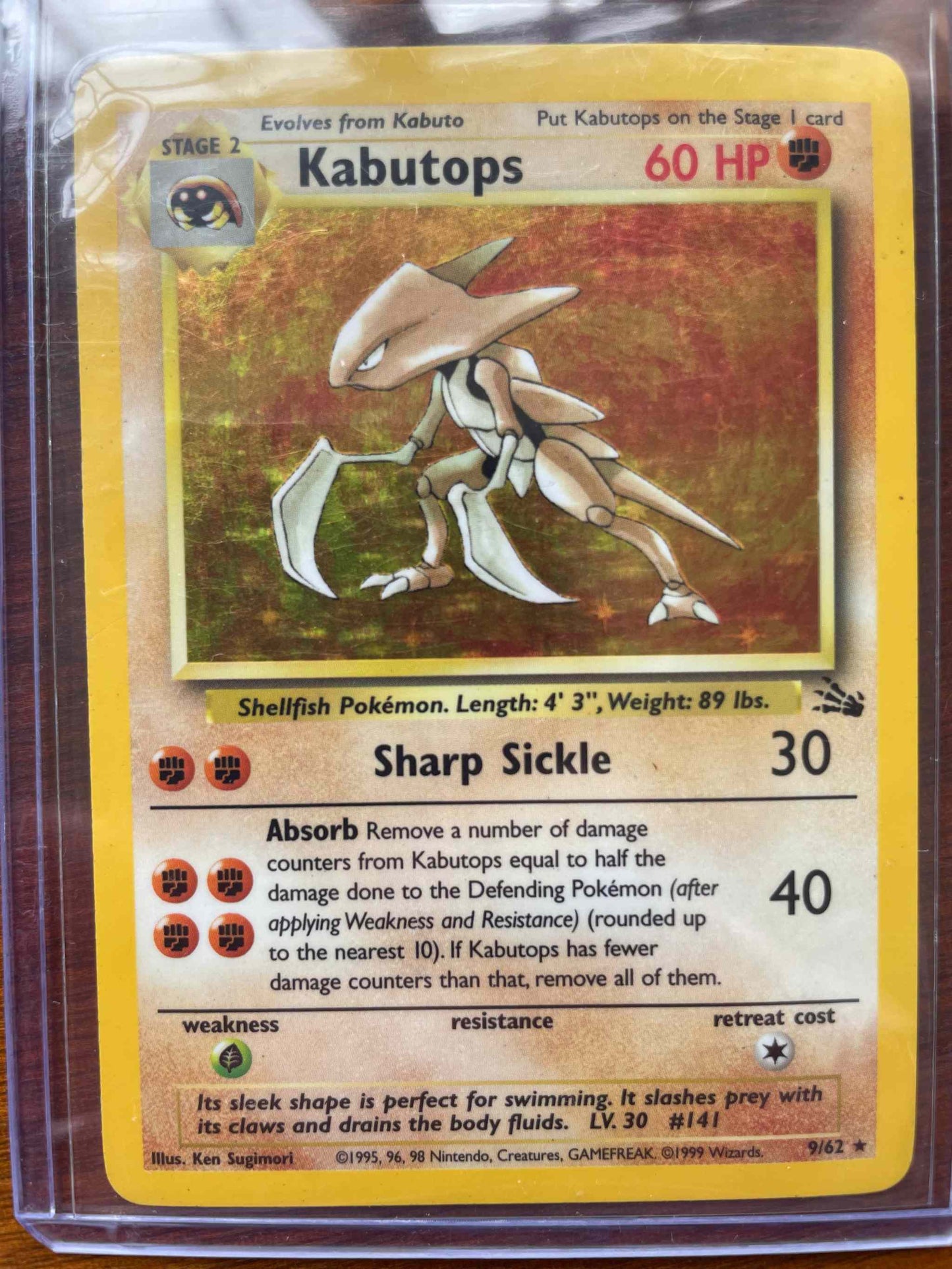 Fossil #09/62 Kabutops collectible Pokemon card in protective sleeve.