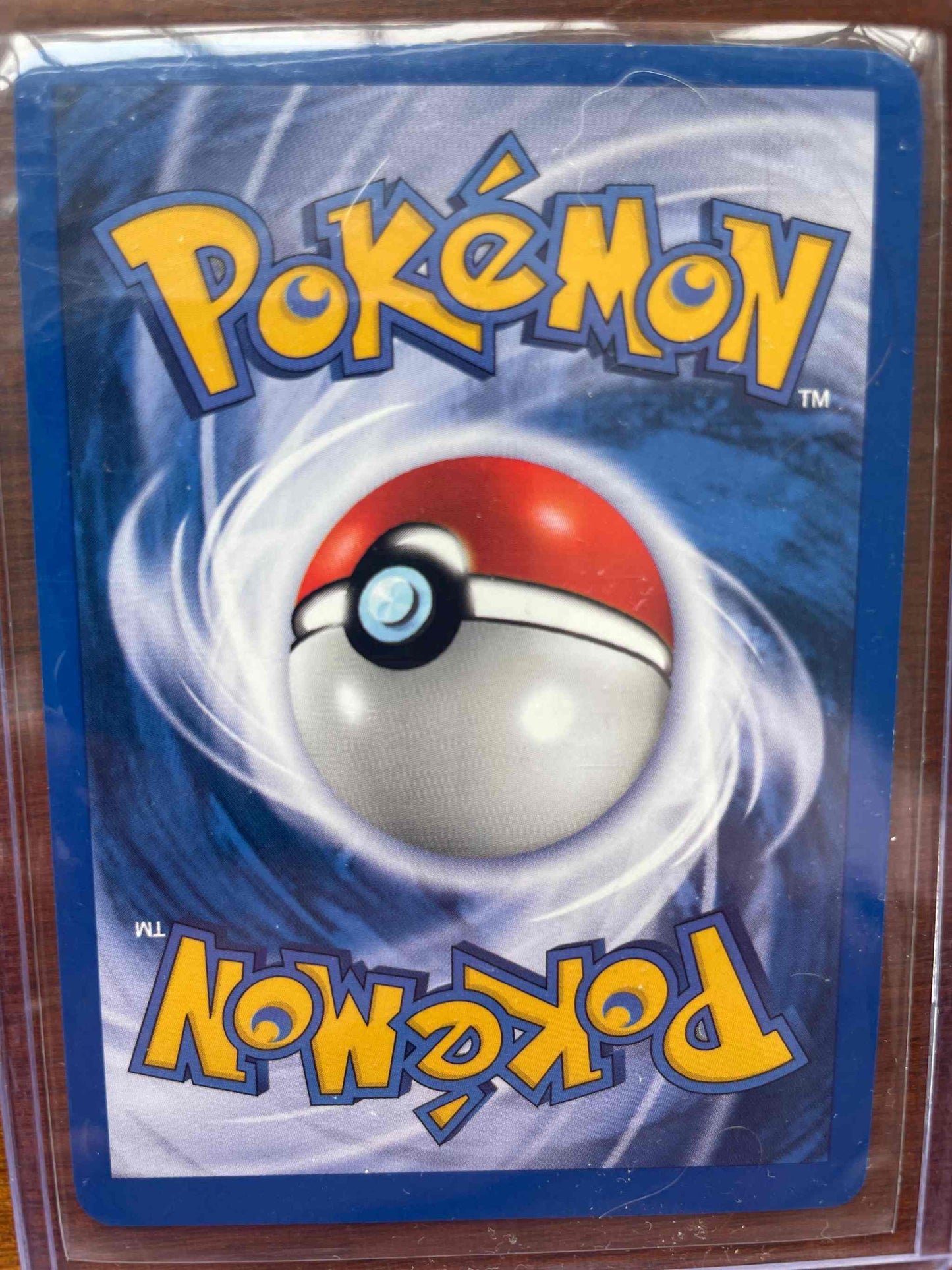 Pokemon trading card featuring Team Rocket's Dark Weezing #14/82 in protective sleeve.