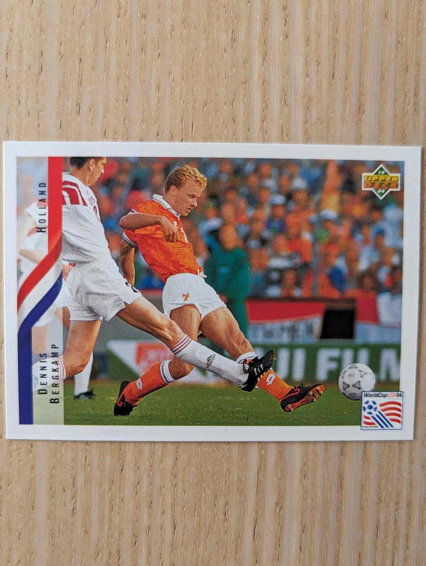 1994 Upper Deck World Cup Contenders card featuring Dennis Bergkamp in action for the Netherlands.