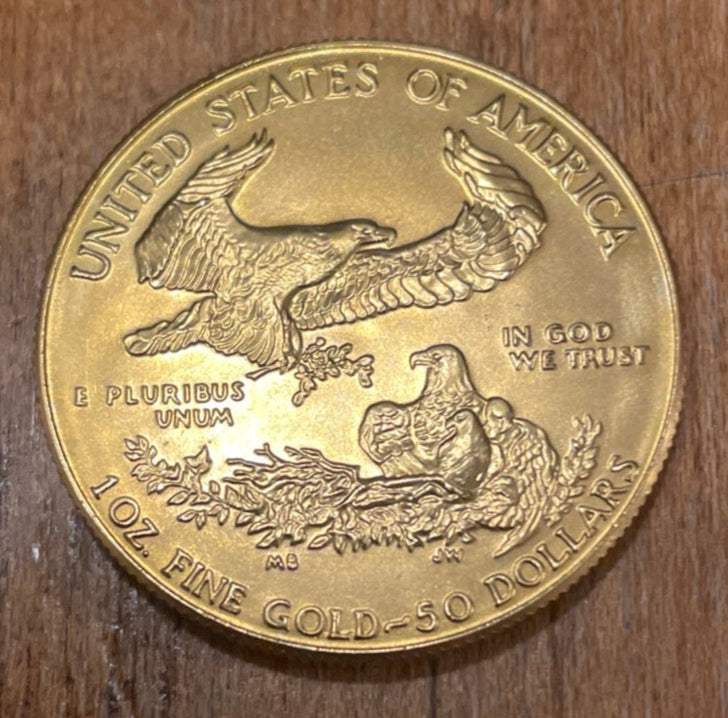 1986 American Eagle $50 Gold GEM BU Coin, featuring bald eagle design, one ounce bullion.