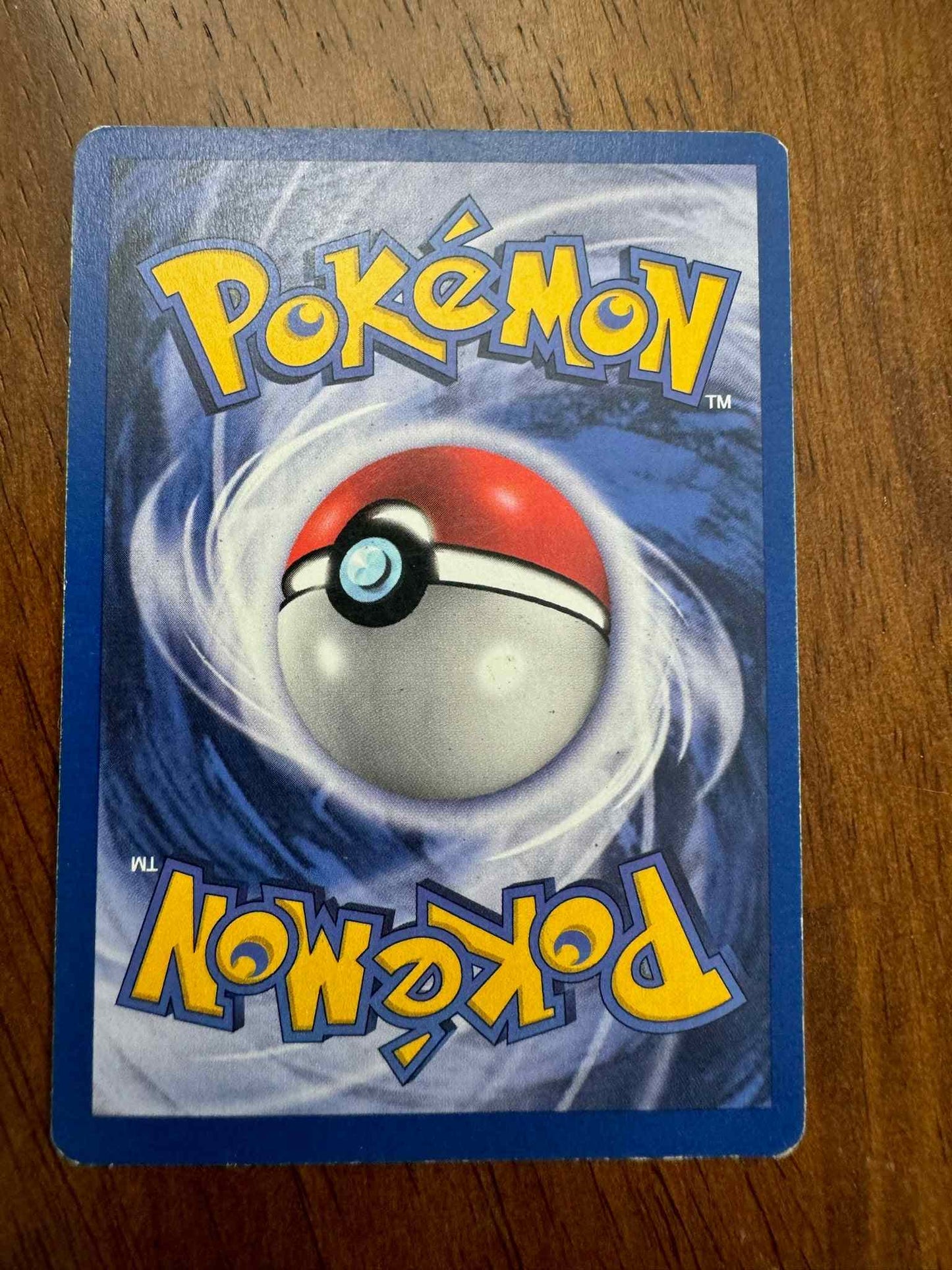 Jungle 22/64 Mr. Mime Pokemon card on wooden surface.
