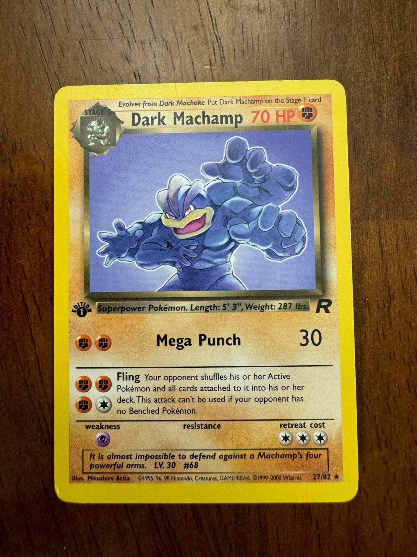 Team Rocket #27/82 Dark Machamp card on a wooden surface.