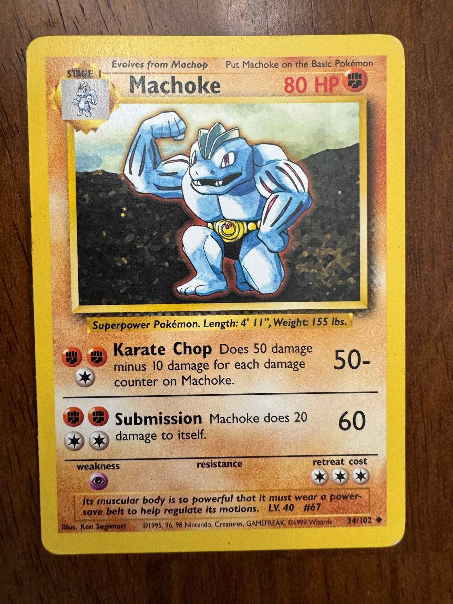 Base Set #034/102 Machoke Pokemon card showcasing Fighting-type abilities.
