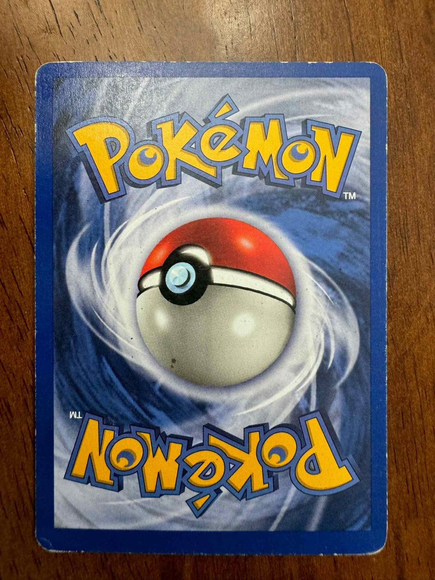 Base Set #040/102 Raticate Pokemon trading card on wooden background.