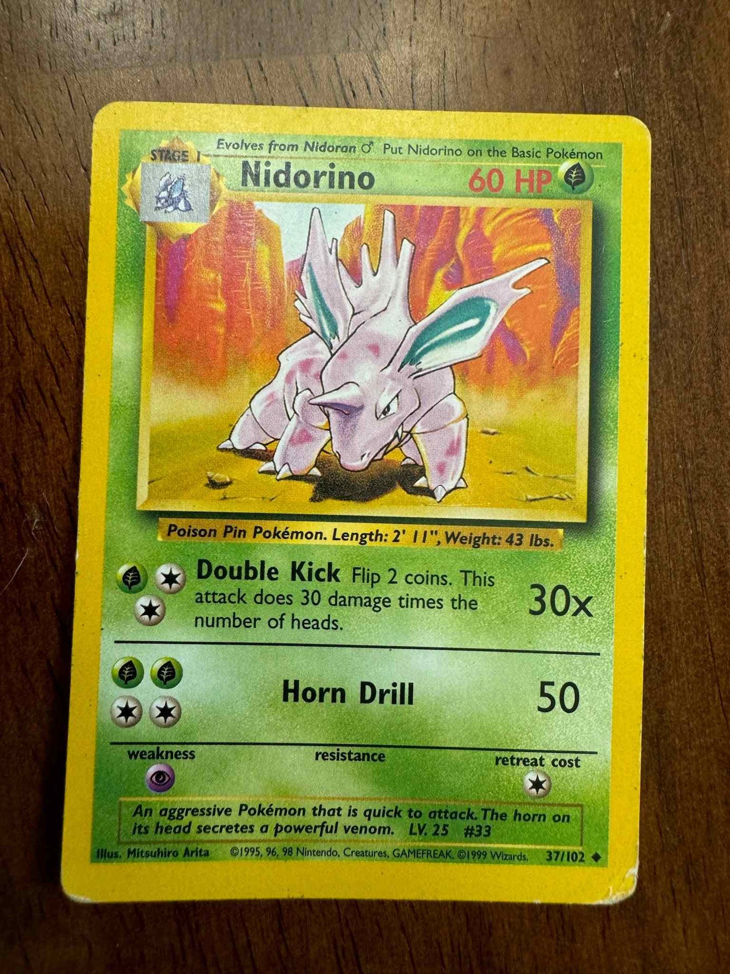 Base Set #037/102 Nidorino trading card with 60 HP and rare abilities.