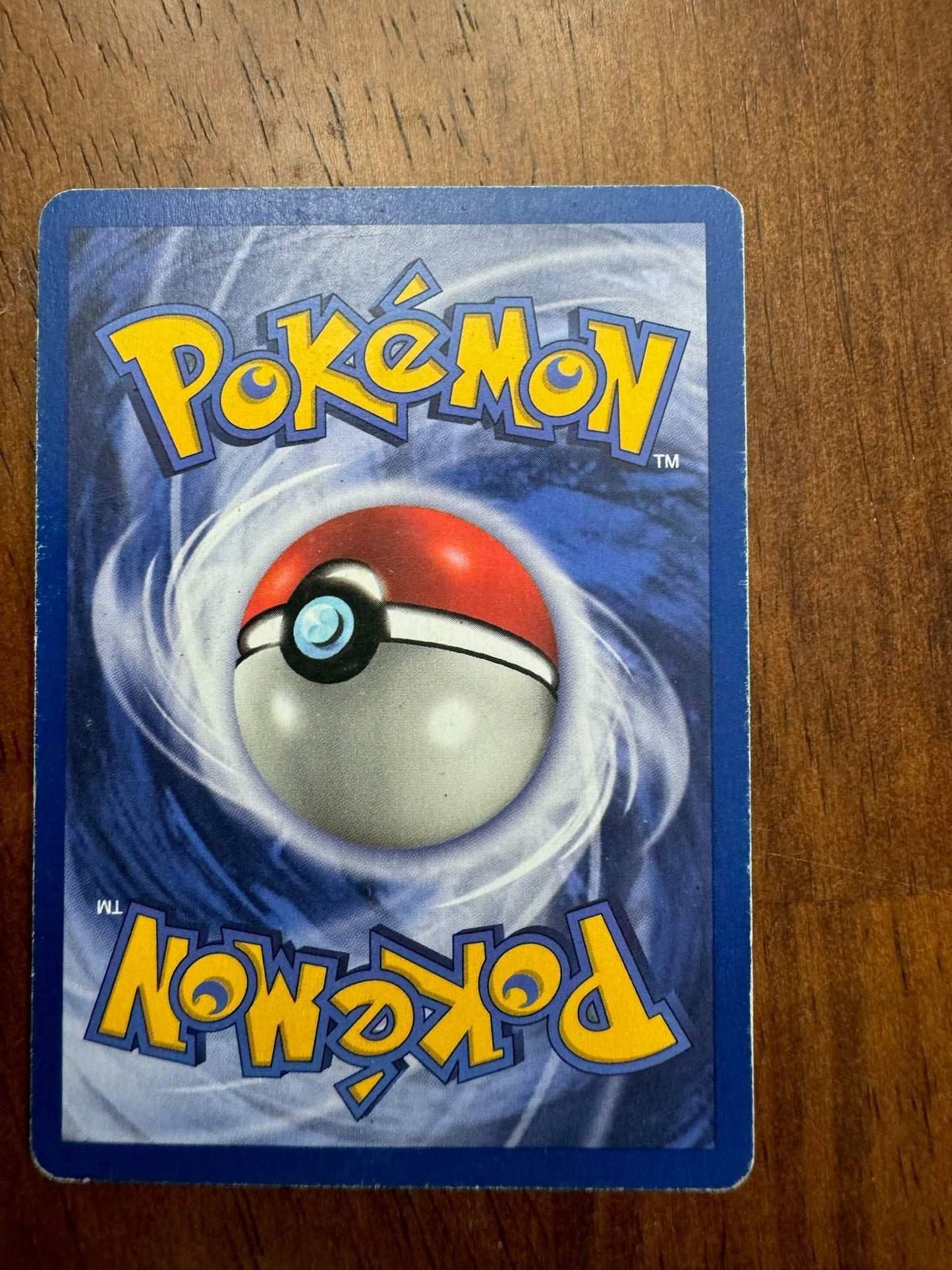 Jungle #31/64 Vileplume (31) collectible Pokémon card on a wooden surface.