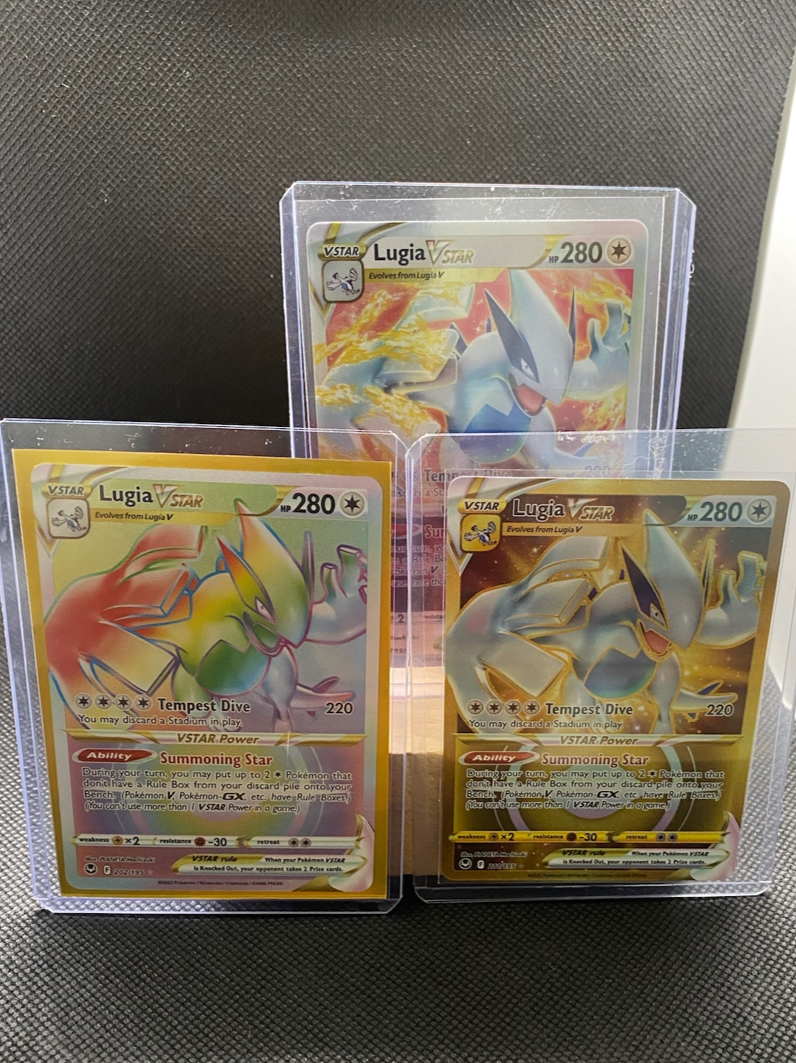 Lugia VSTAR lot of 3 rainbow and gold secret rare cards, full art, near mint condition.