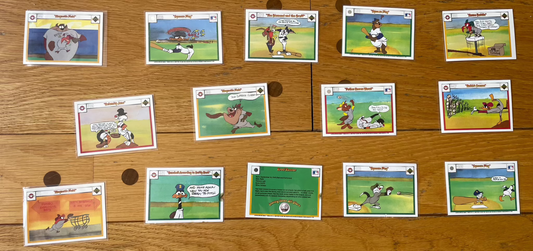 Lot of 28 Looney Tunes Upper Deck 1990 Warner Bros. trading cards displayed on a wooden surface.