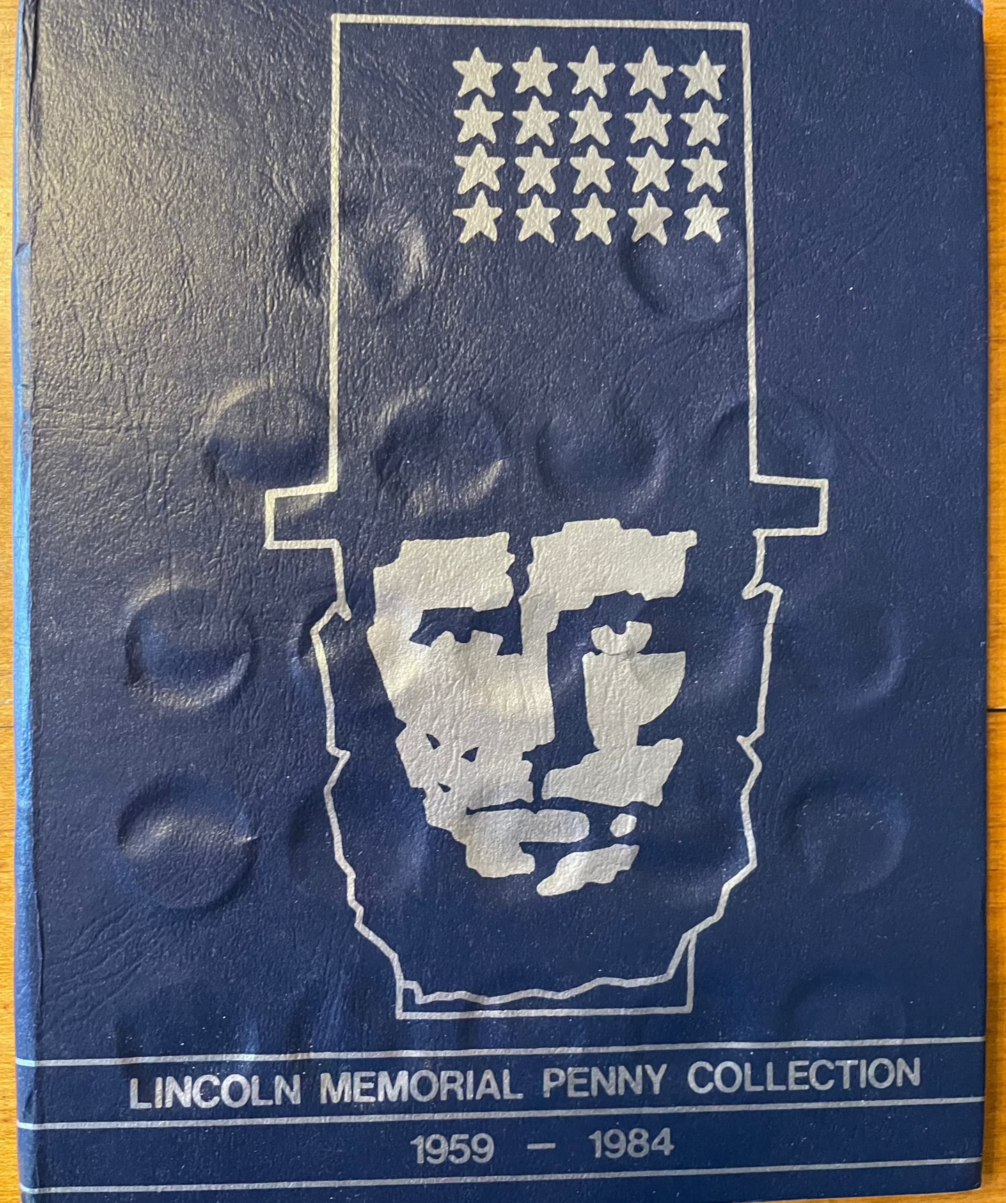 Collector's lot of four penny books with Indian Head and near-mint steel cents bonus displayed in a well-preserved Lincoln Memorial Penny Collection book from 1959 to 1984.