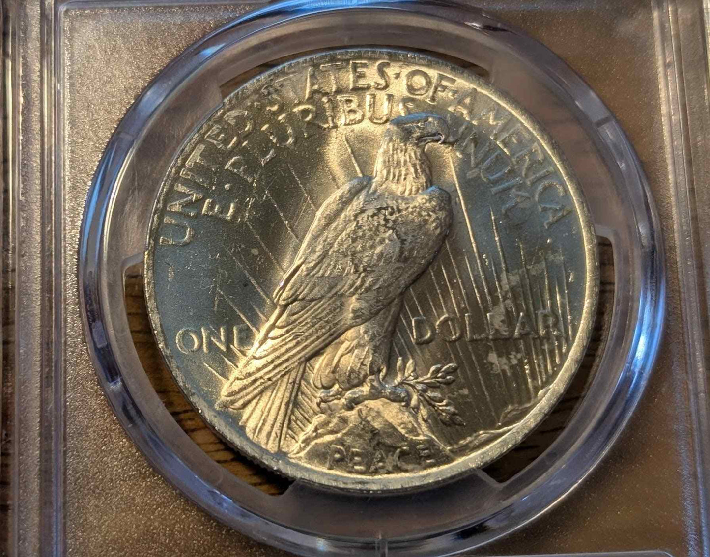 1922 Peace Silver Dollar MS63 coin in protective casing.