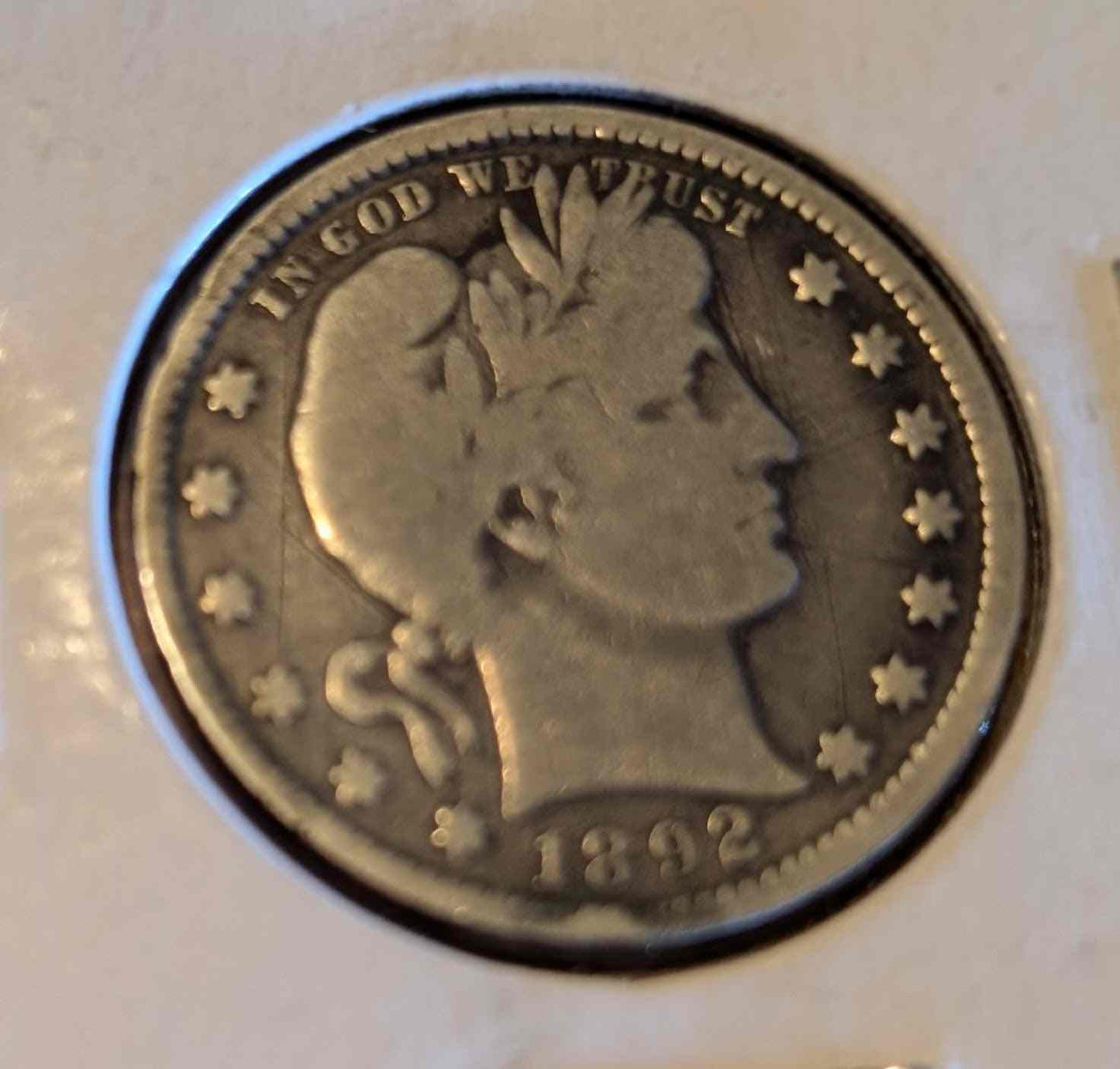 1892 Barber Quarter coin with minor wear showing historical design and craftsmanship.