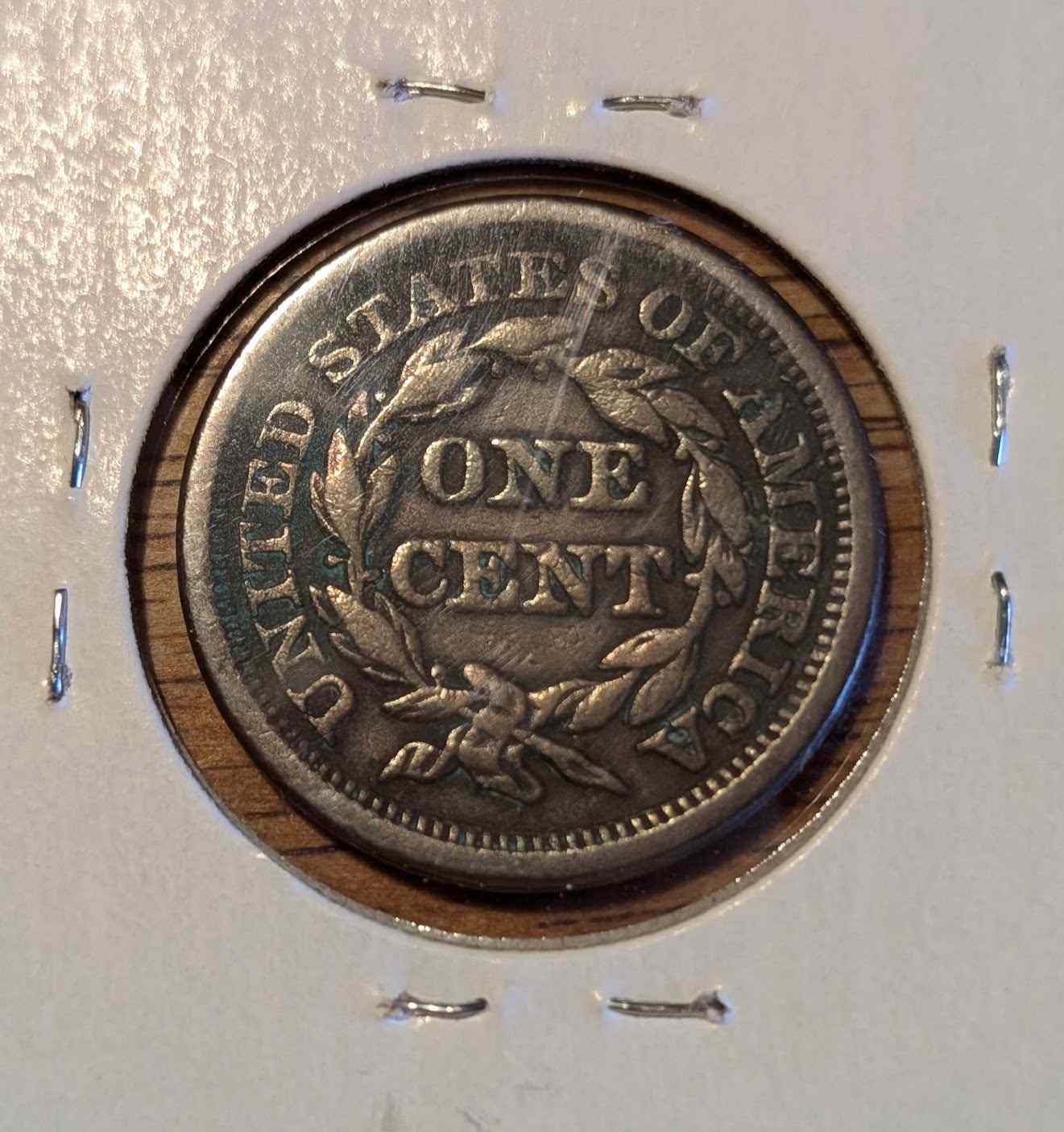 1848 Braided Hair Large Cent coin with intricate design in protective casing.