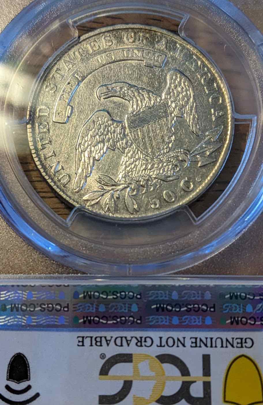 1835 Capped Bust Half Dollar VF20 coin in protective case, vintage numismatic collectible.