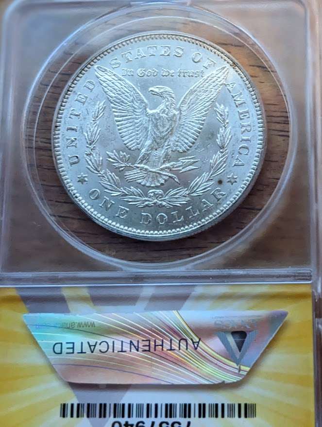 1878 Morgan Silver Dollar with 7 tailfeathers in mint state 61, encased and authenticated.