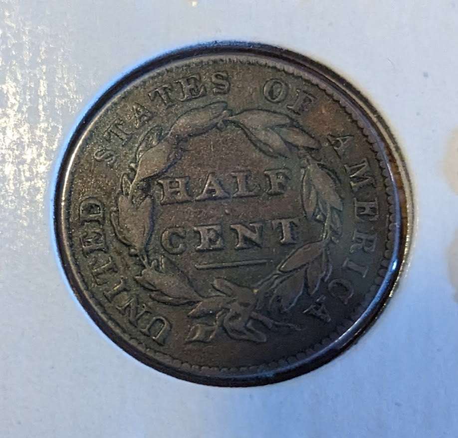 1826 Classic Head Half Cent coin, showing intricate reverse design and iconic Liberty profile.