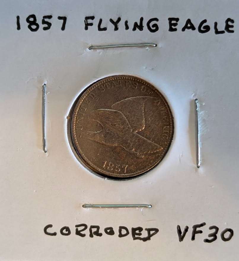 1857 Flying Eagle Cent in corroded VF30 condition, showcasing historic American coinage design.