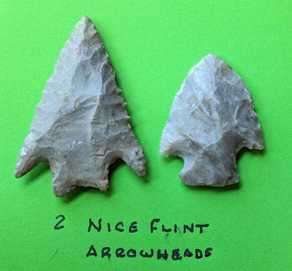Pair of authentic Native American flint arrowheads with classic triangular and notched forms crafted from high-quality chert
