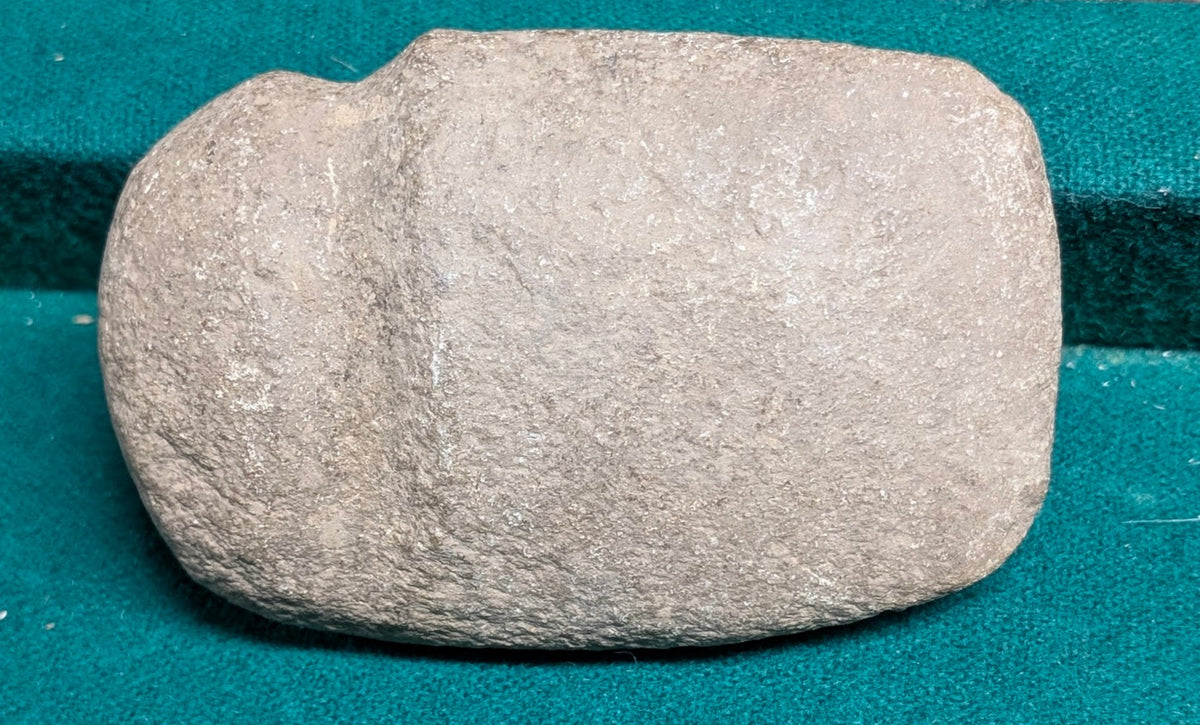 Native American grooved stone axe head artifact with weathered gray stone and hafting groove