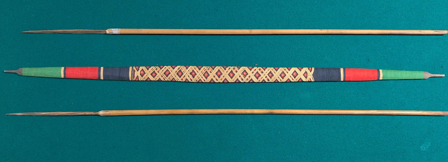 Handcrafted Indigenous style wooden bow with woven grip and two arrows in tribal design