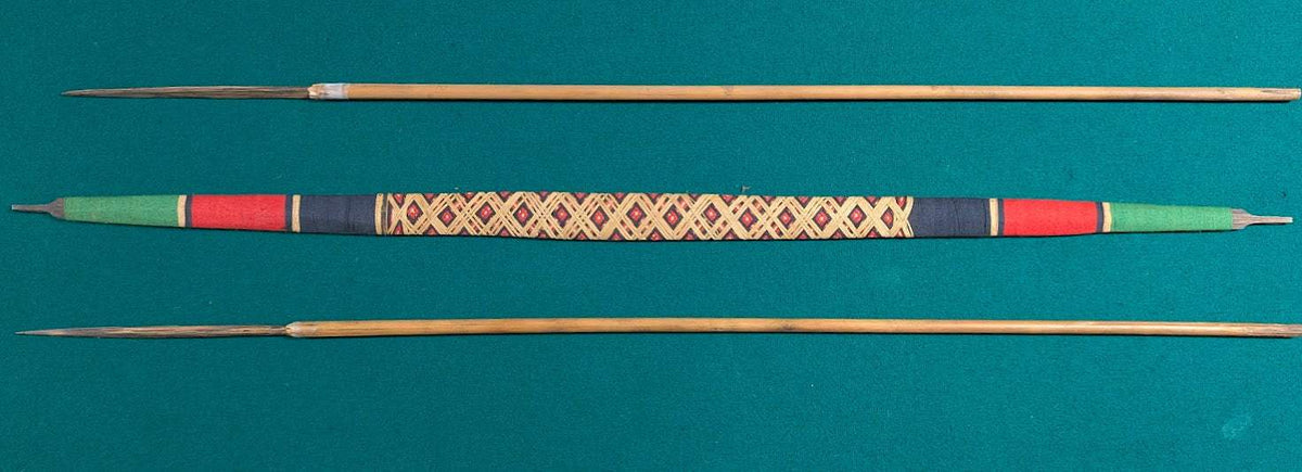 Handcrafted Indigenous style wooden bow with woven grip and two arrows in tribal design