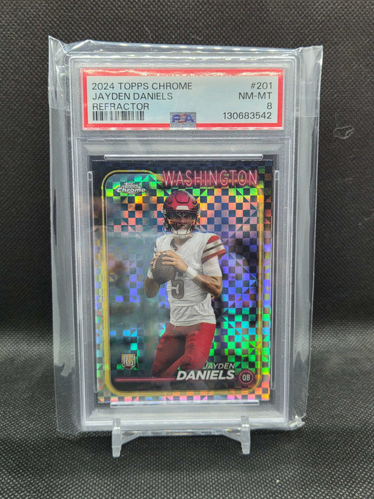 2024 Topps Chrome football rookie card featuring Jayden Daniels in Washington uniform with colorful refractor checkerboard pattern and PSA 8 grading.