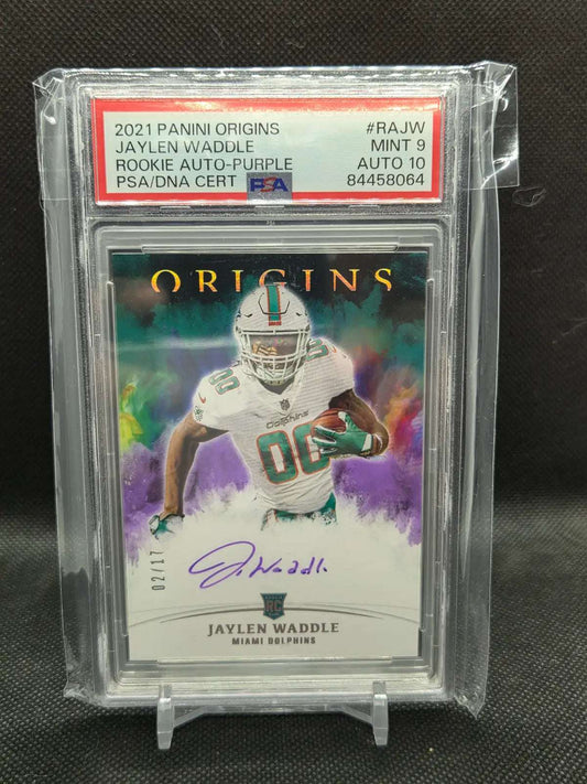 2021 Panini Origins rookie autograph football card, featuring Jaylen Waddle in a white Dolphins uniform, purple watercolor design and signature.