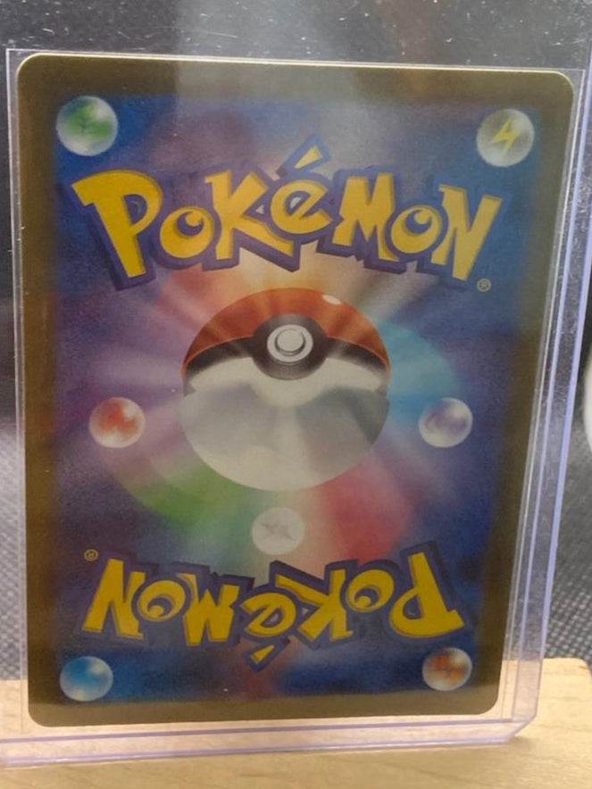 Rare Paldea Evolved Skeledirge ex Pokémon card in protective sleeve.