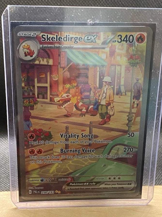 Paldea Evolved #258/193 Skeledirge ex card in protective case, featuring Vitality Song and Burning Voice attacks.