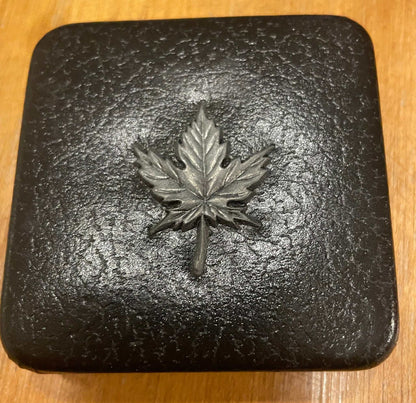 1983 commemorative medal case with Canadian maple leaf emblem.