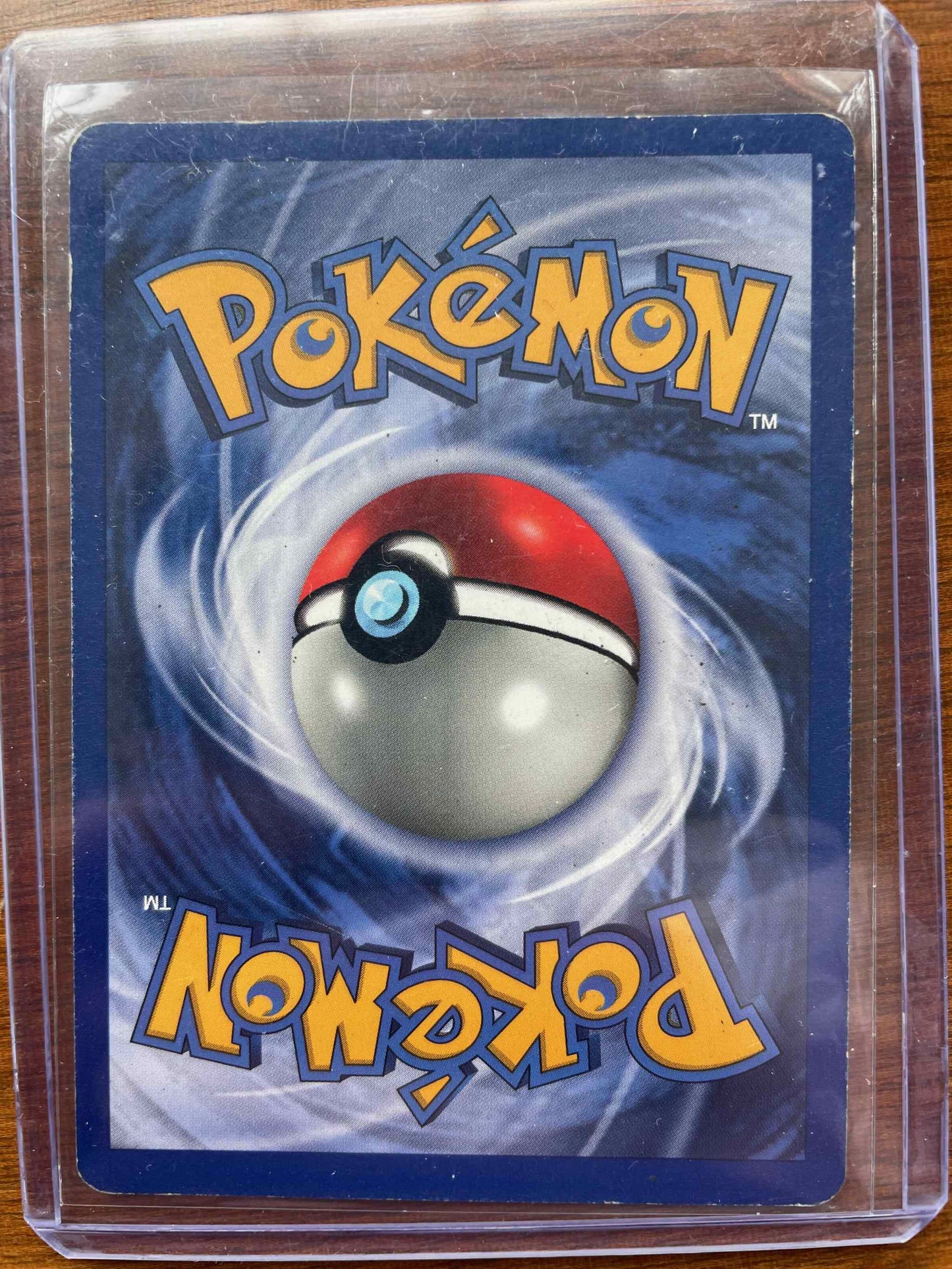 Deck Exclusives #008/102 Machamp card in protective sleeve, Pokémon collectible.