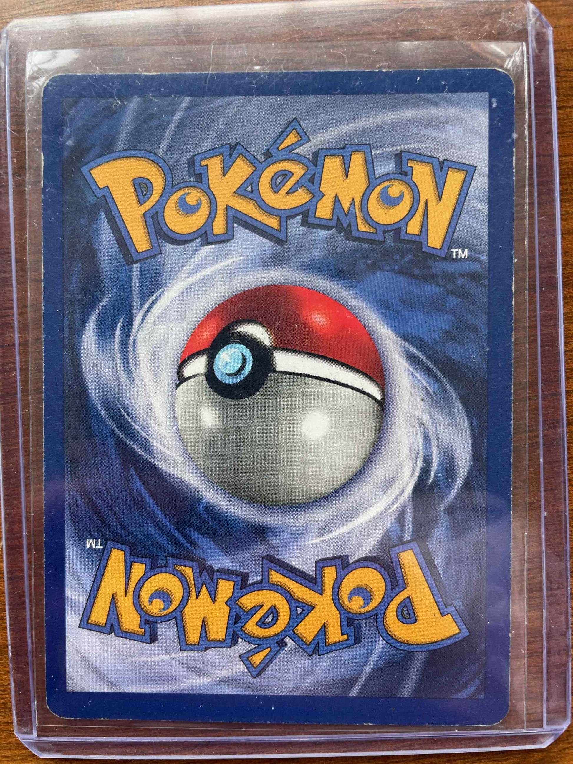 Deck Exclusives #008/102 Machamp card in protective sleeve, Pokémon collectible.