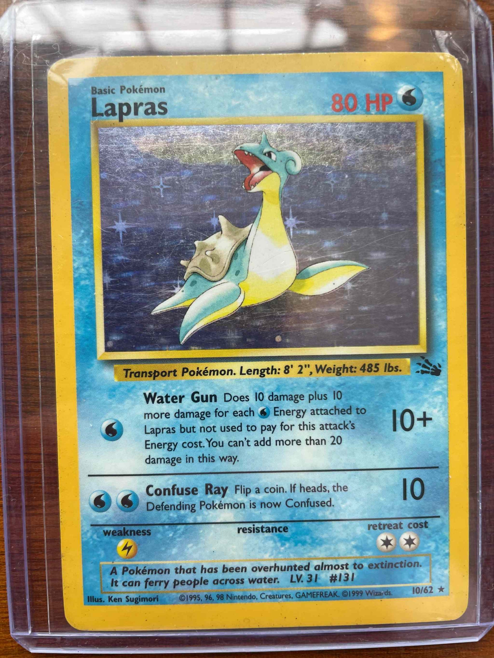 Fossil #10/62 Lapras Pokémon card in protective sleeve.