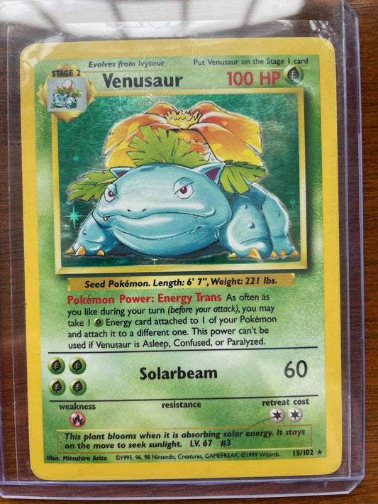 Base Set 2 Venusaur #015/102 collectible trading card in protective sleeve.