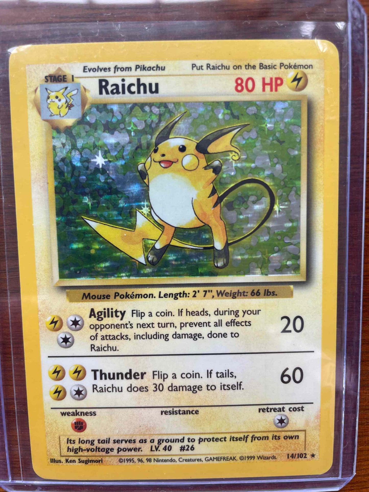 Base Set #014/102 Raichu Pokemon card featuring electric type design and gameplay stats.