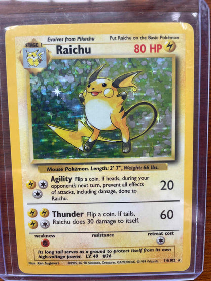 Base Set #014/102 Raichu Pokemon card featuring electric type design and gameplay stats.