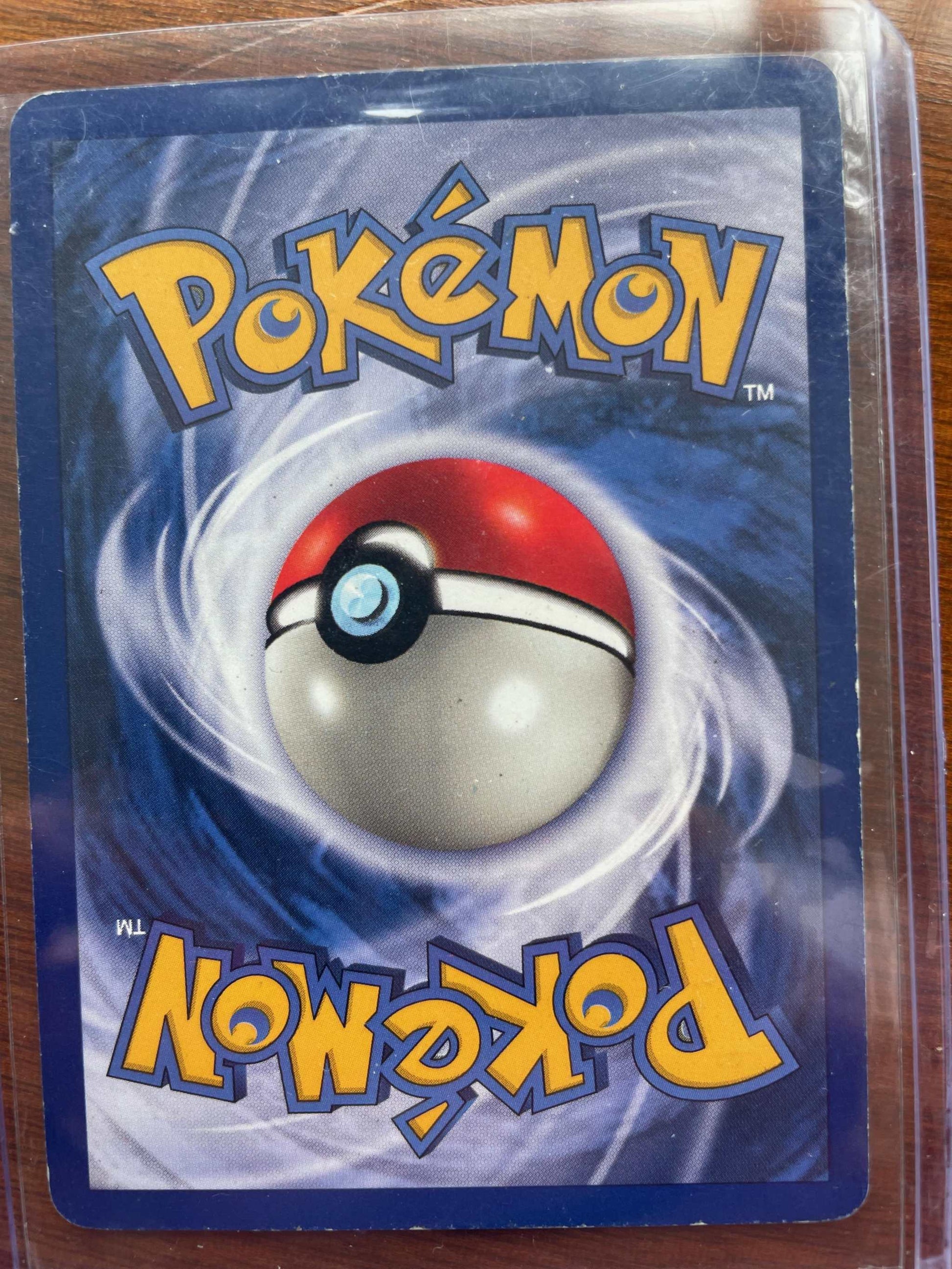Fossil #14/62 Raichu Pokémon card in protective sleeve.