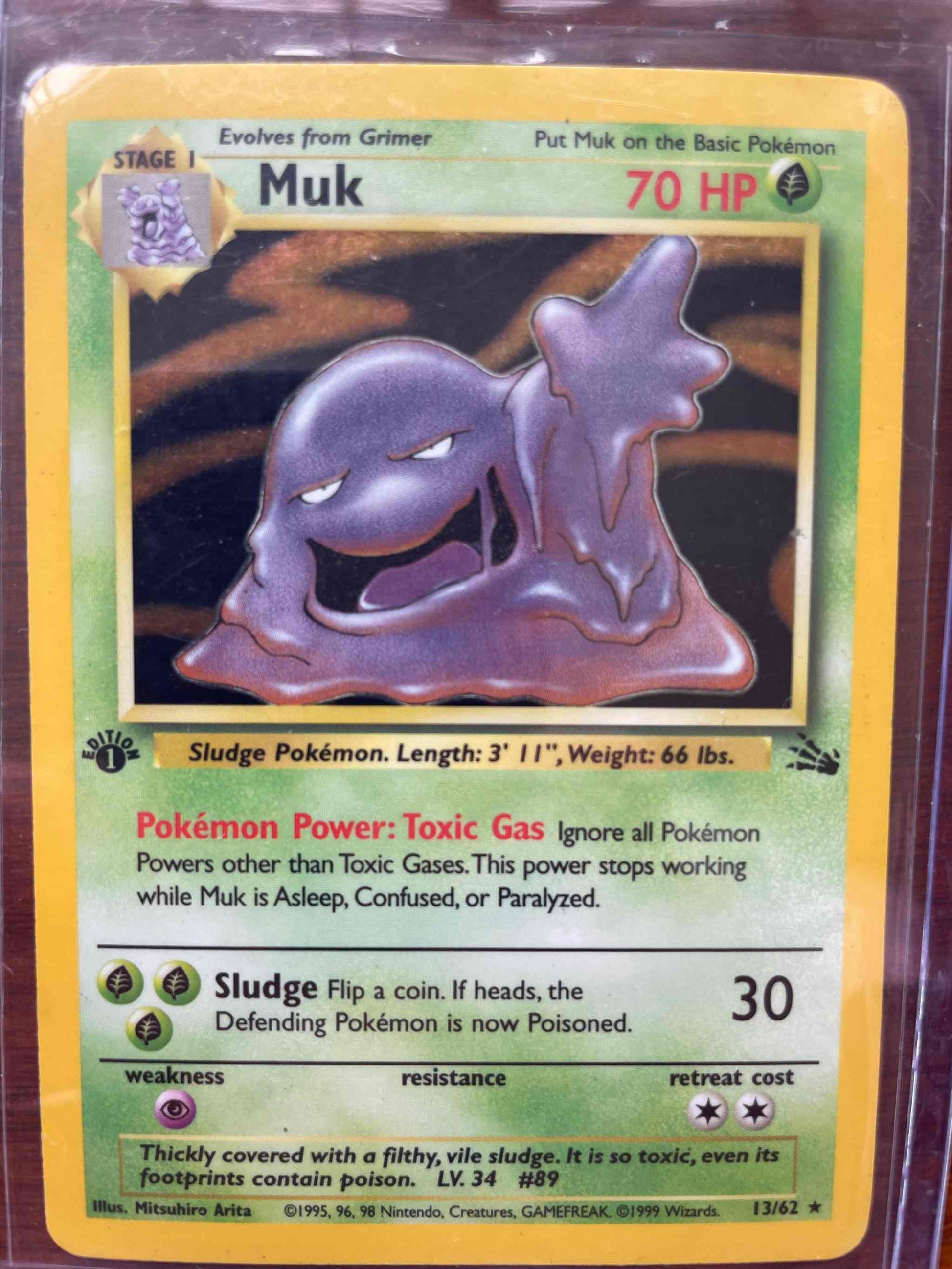 Fossil #13/62 Muk Pokémon collectible card with unique design and impressive stats.