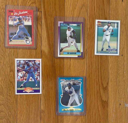 Bo Jackson sports card bundle featuring five collectible cards on hardwood surface.