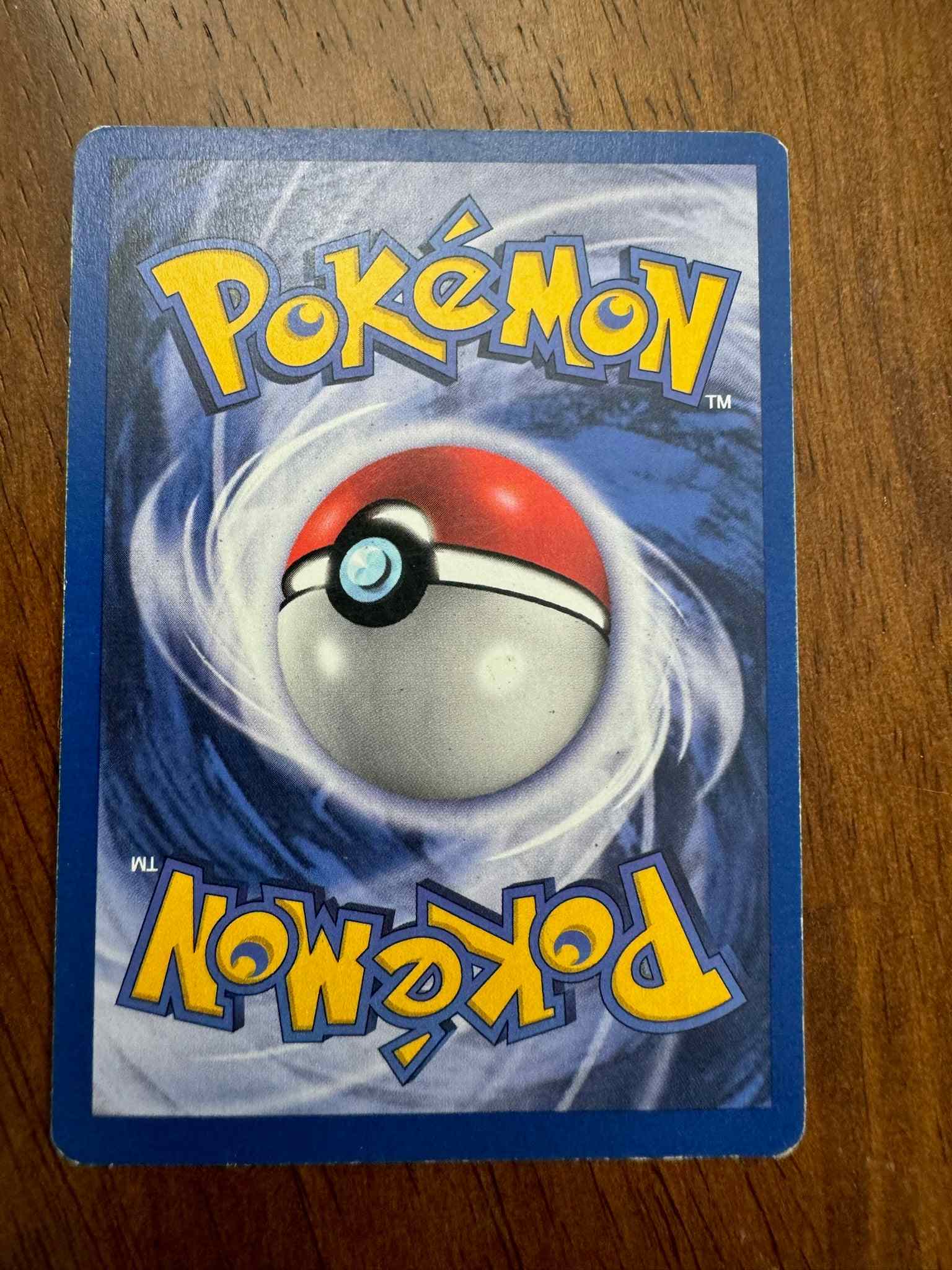 Jungle 22/64 Mr. Mime Pokemon card on wooden surface.