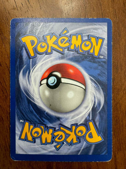 Base Set #040/102 Raticate Pokemon trading card on wooden background.