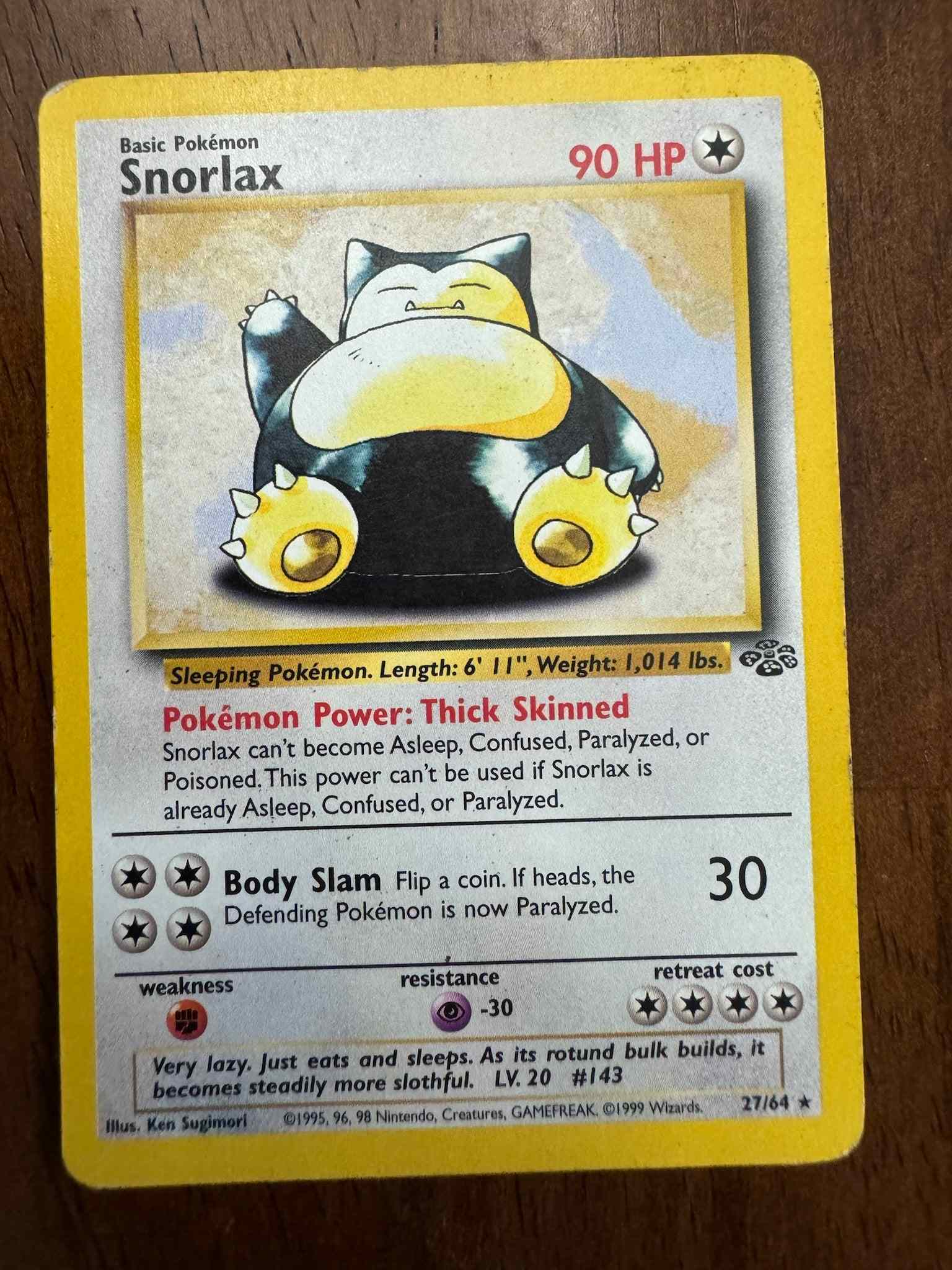 Jungle #27/64 Snorlax Pokémon card with unique design and impressive stats.