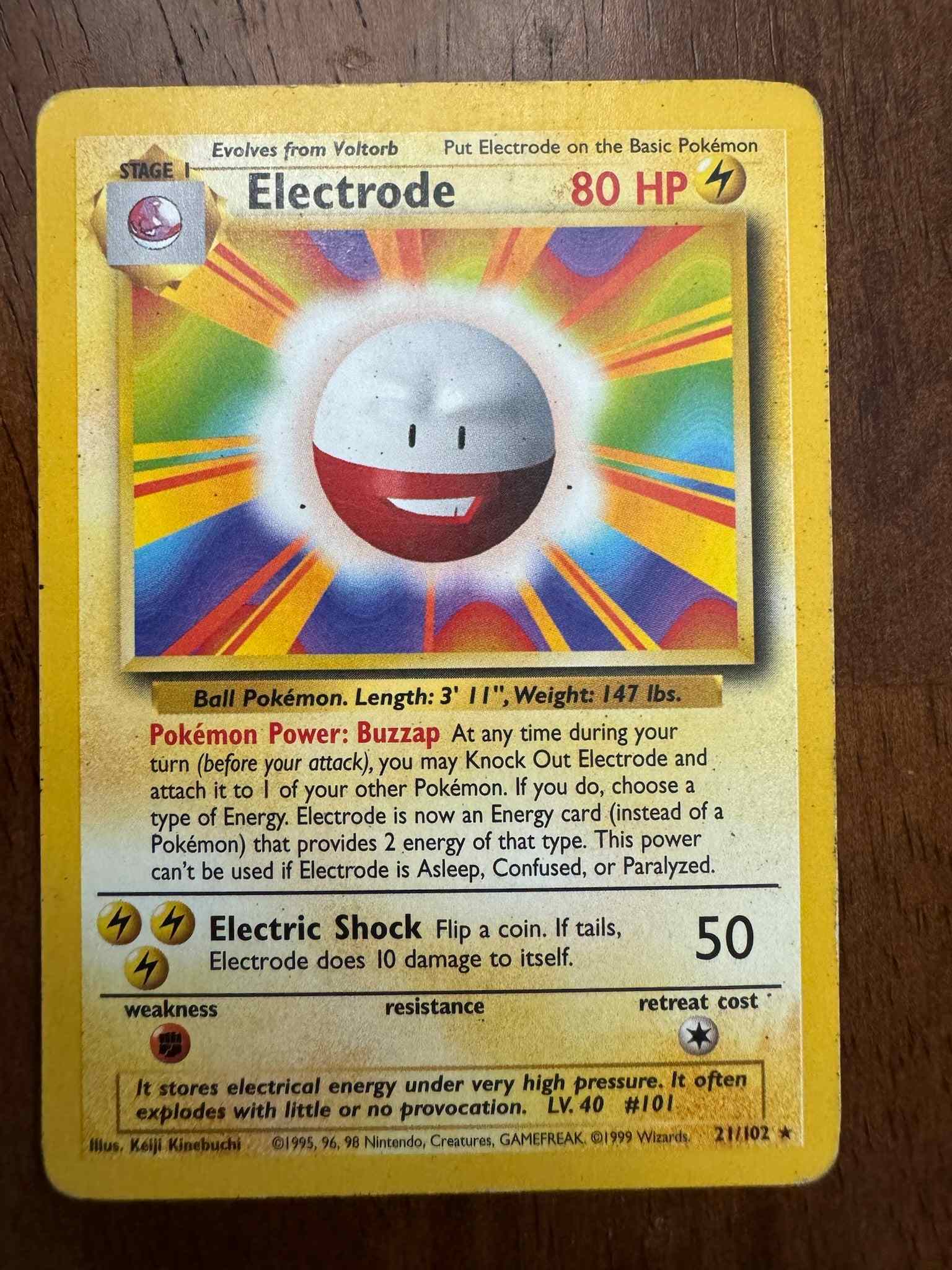 Base Set #021/102 Electrode trading card on a wooden background.