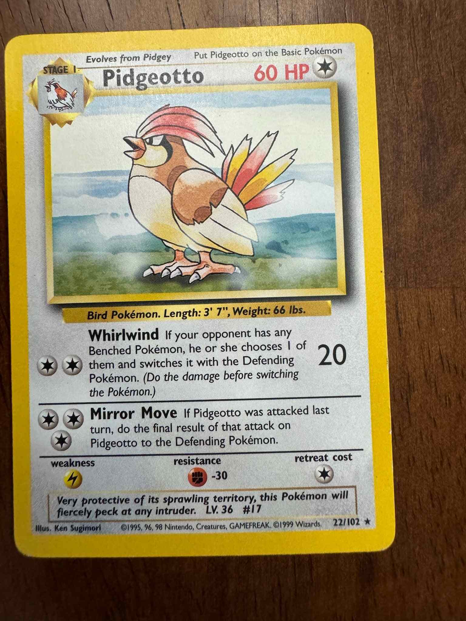 Base Set #022/102 Pidgeotto collectible trading card on table.