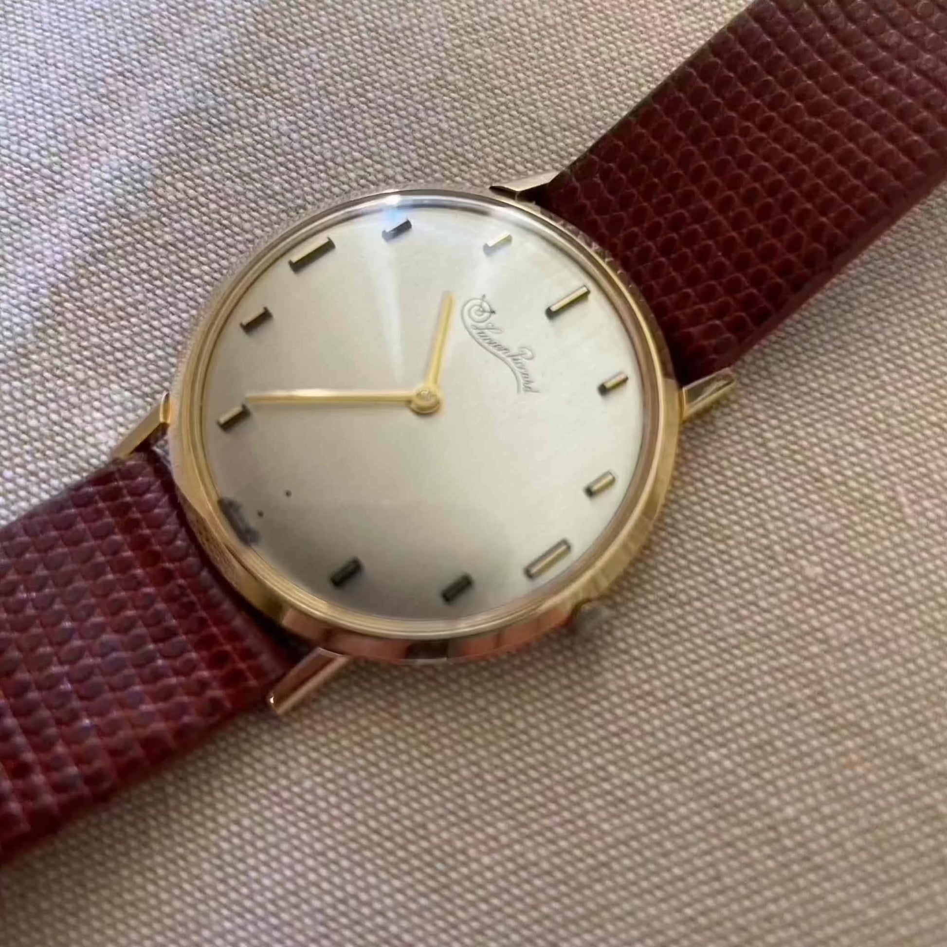 Vintage Lucien Piccard ultra slim 14k gold mechanical watch with brown strap.