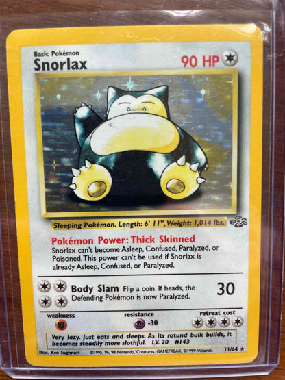 Jungle #11/64 Snorlax Pokemon card in protective case.