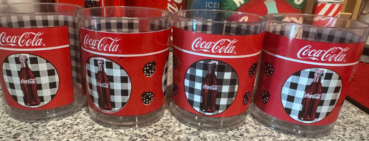Set of 4 vintage Coca-Cola checkered glass tumblers with red branding and bottle designs
