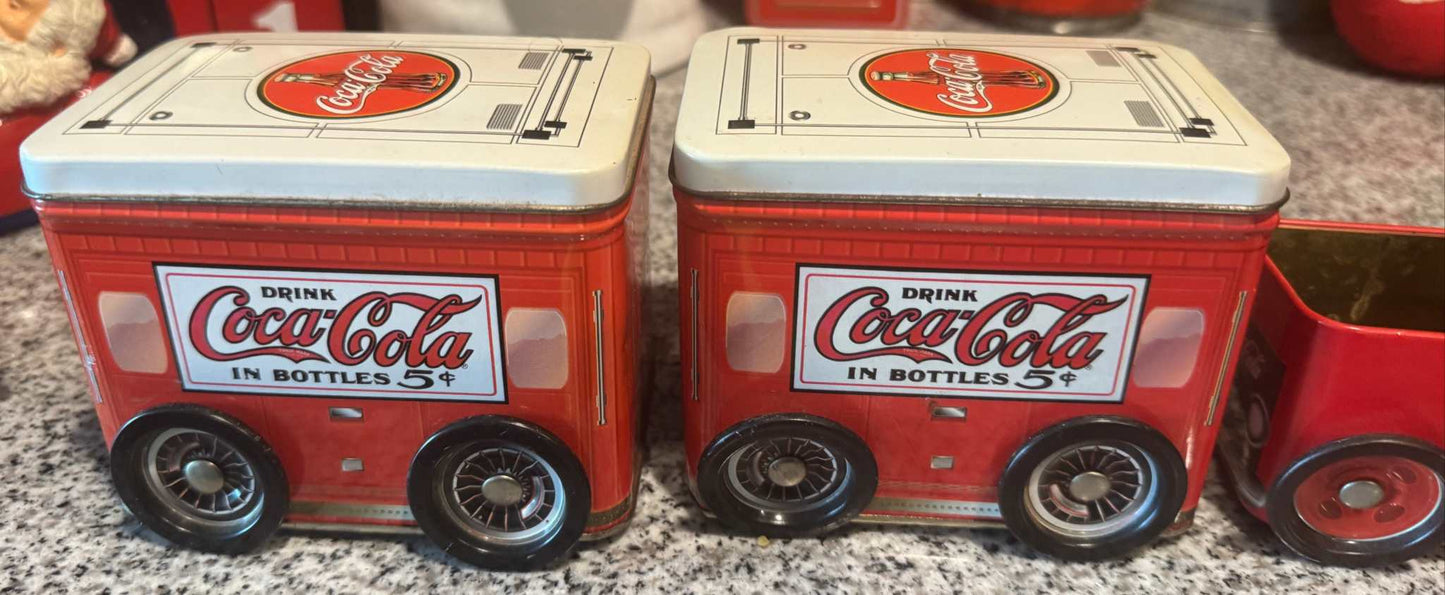 Vintage Coca-Cola delivery truck tin canister set with embossed wheels and classic red Coke branding